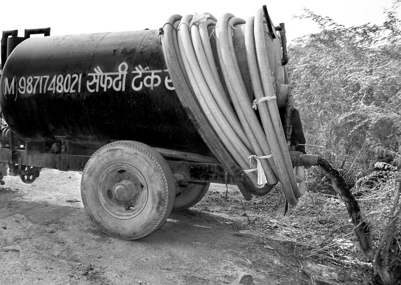 A sewage tanker emptying into Najafgarh Drain in South-West district, National Capital Territory of Delhi, ultimately contributing to pollution of Yamuna river